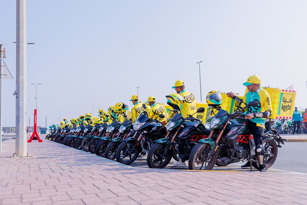 A line of YaBalash delivery motorcycles and riders ready for dispatch.